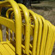 Lot of 11 yellow metallic bistro chairs from the 1950s