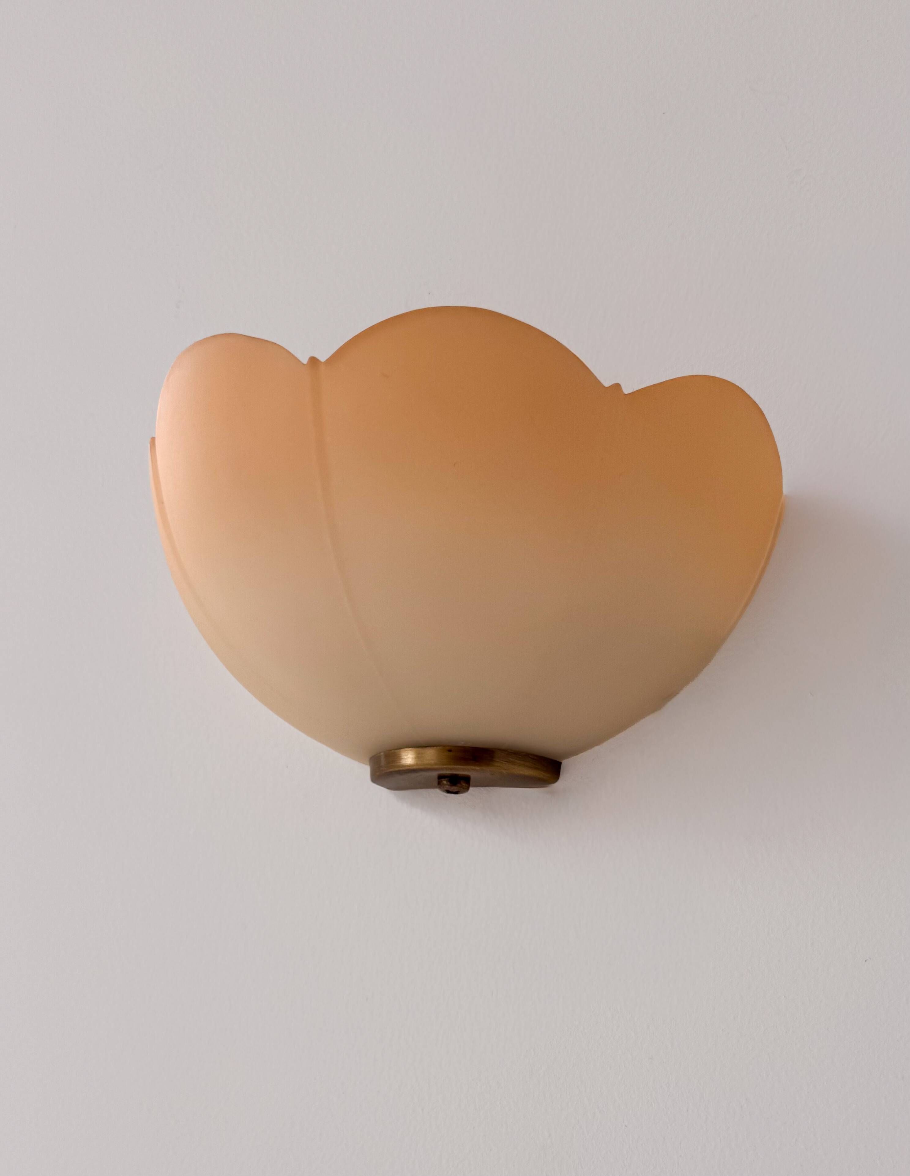 Vintage brass and orange glass wall lights, France 1970.