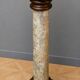 Column-shaped pedestal, made of solid wood and faux marble paint.