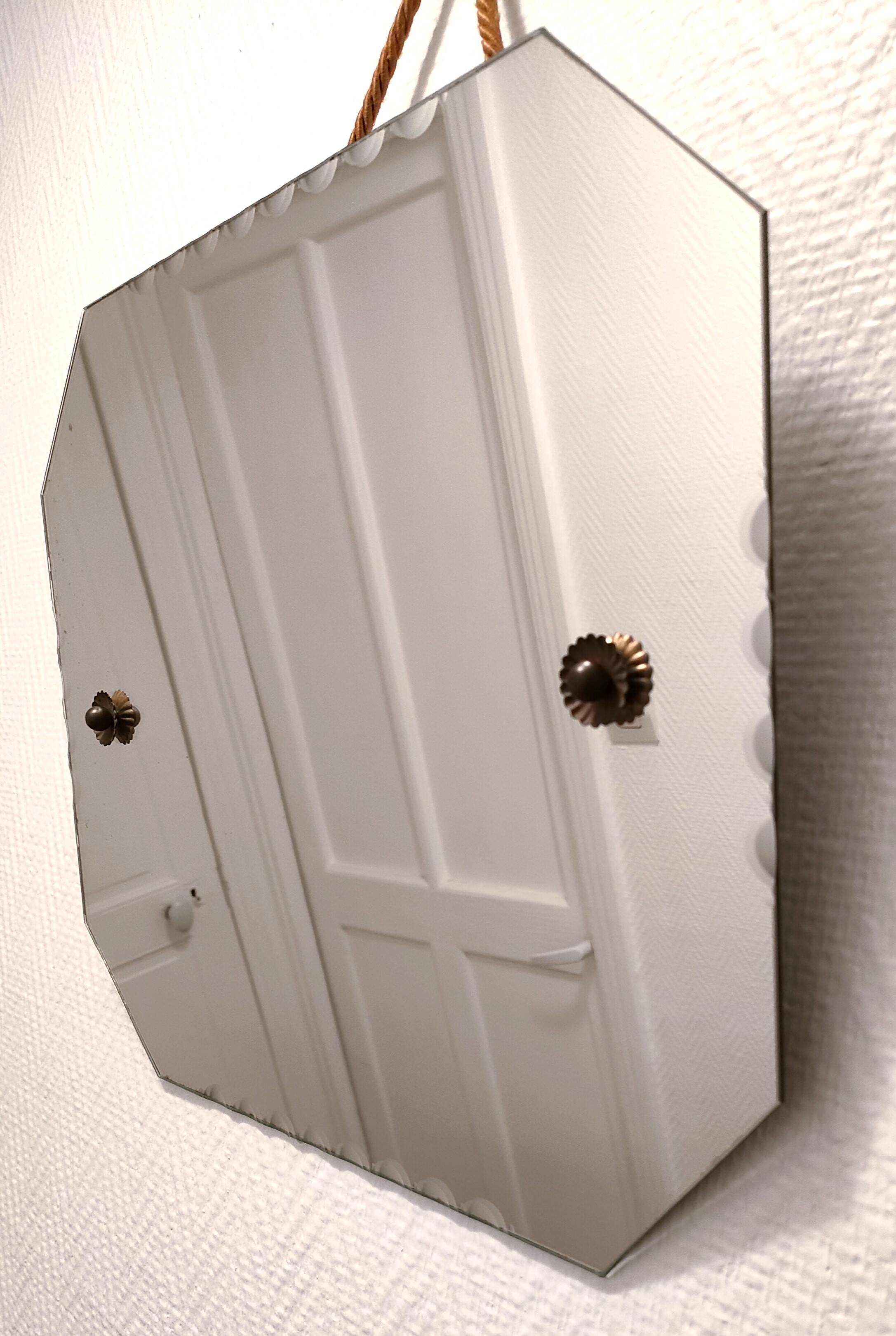 Octagonal mirror with brass hubcaps from the 60s