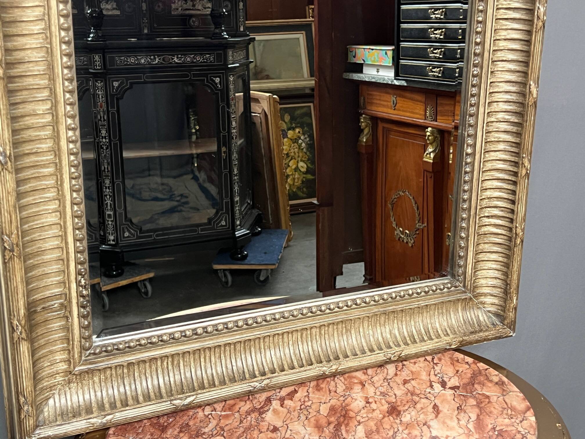 Mirror in a frame with a moulding.