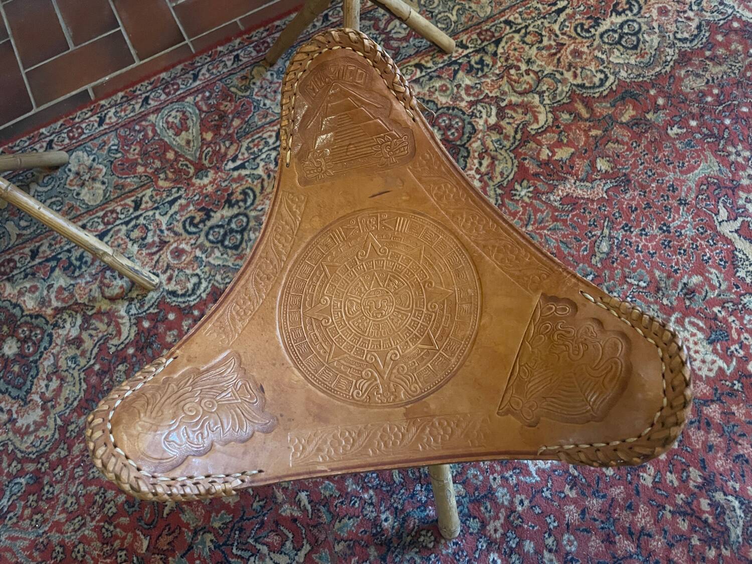 Vintage Mexican tripod stools in bamboo and leather.