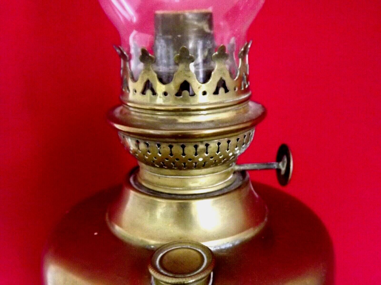 Vintage brass oil lantern with decorative base and transparent glass funnel stamped L B Brand Delay 4399.