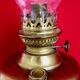 Vintage brass oil lantern with decorative base and transparent glass funnel stamped L B Brand Delay 4399.