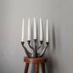 Vintage bronze candlestick chandelier in contemporary Scandinavian design.