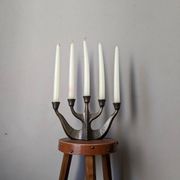 Vintage bronze candlestick chandelier in contemporary Scandinavian design.