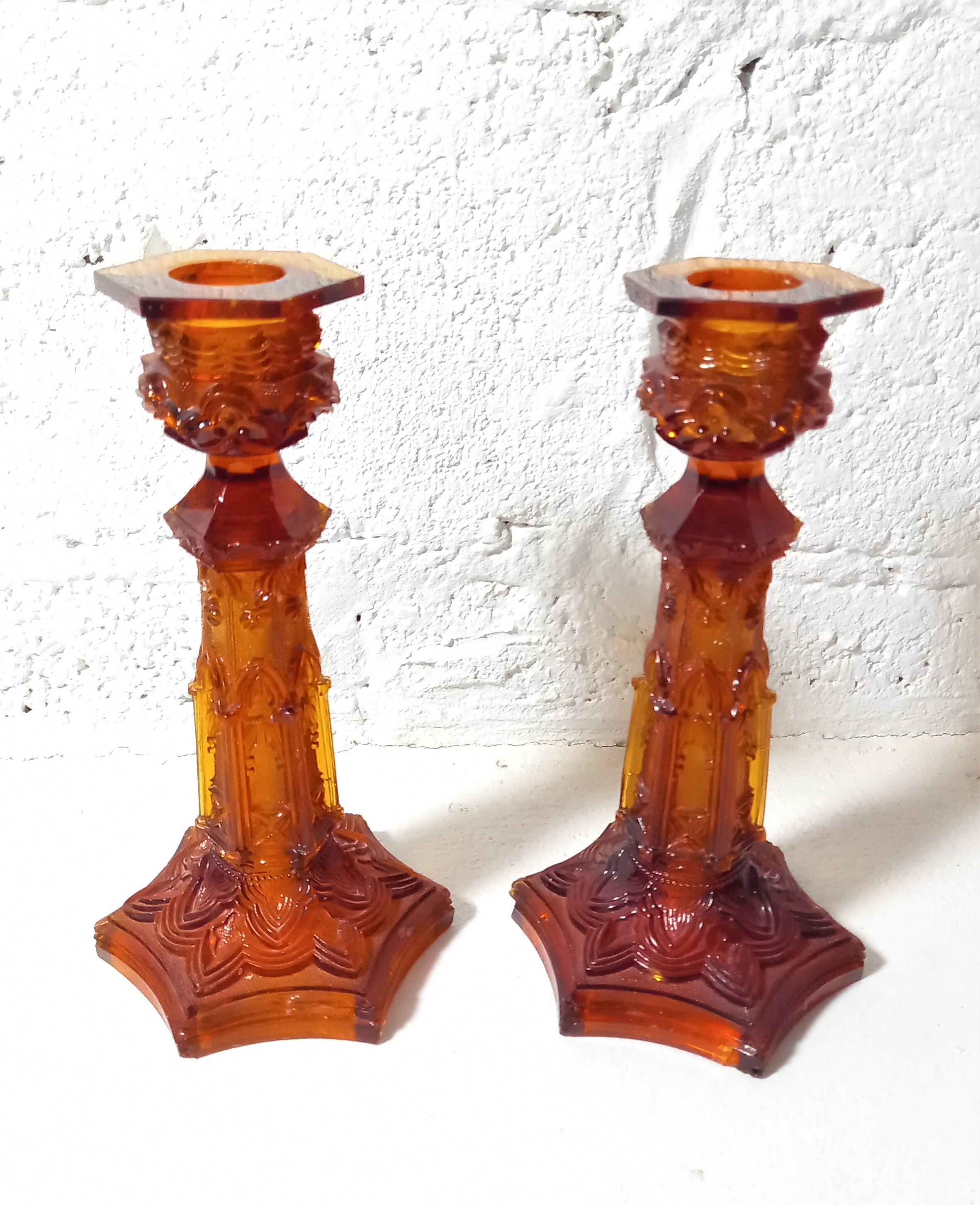 Pair of amber glass torches decorated with gothic motifs