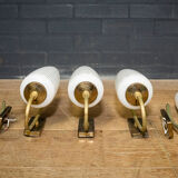 Ornate wall lamp made of milk glass and brass