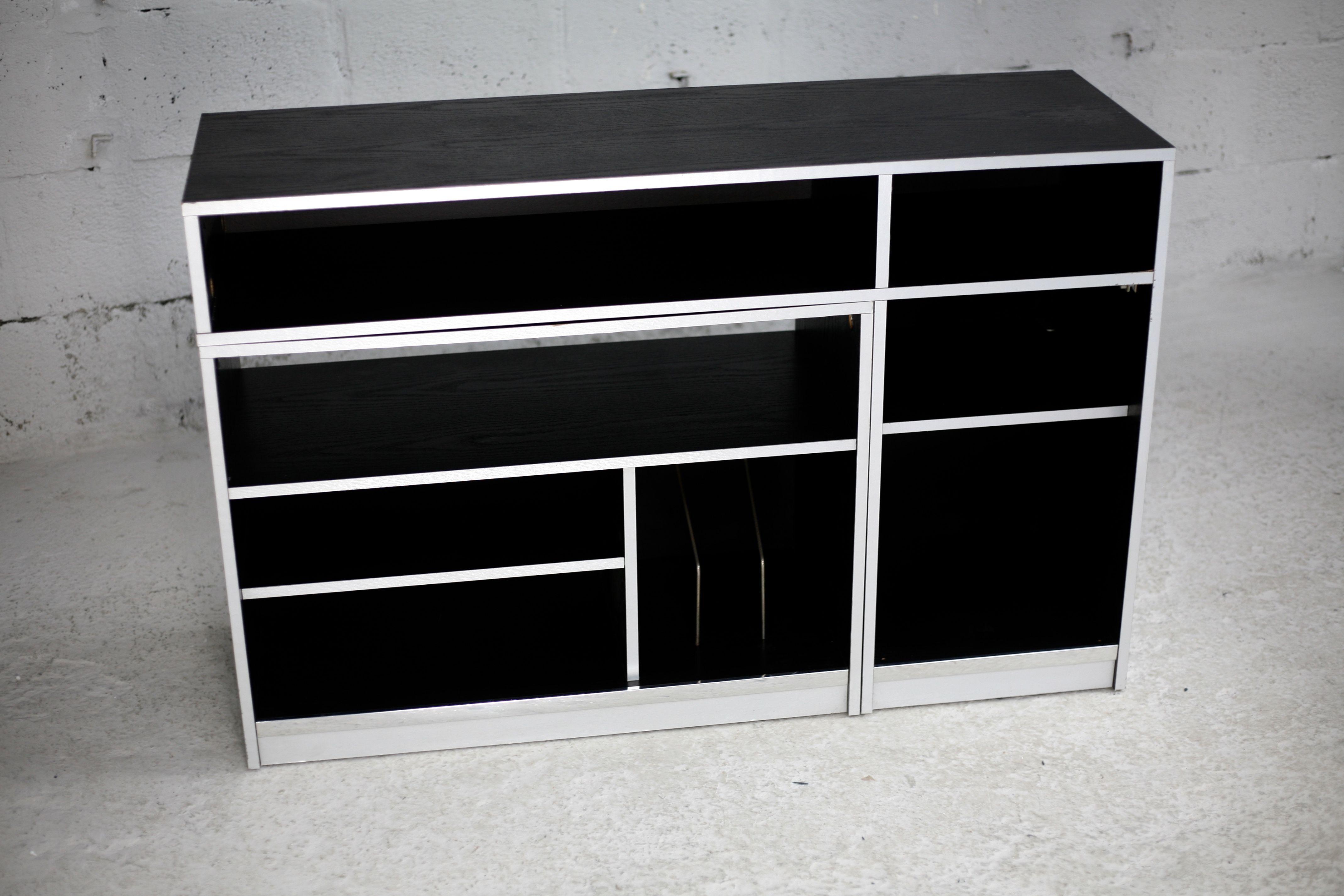 Storage cabinet wood compressed lacquered black lining margins aluminum. France, circa 1975.