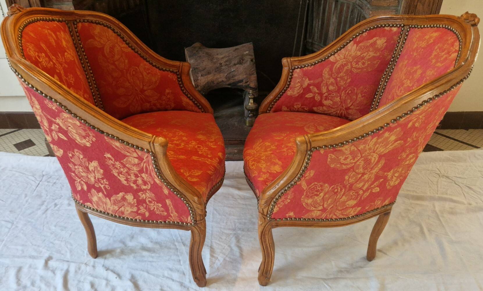 Pair of louis xv cabriolet armchairs with sculpted wood and pink & red floral fabric