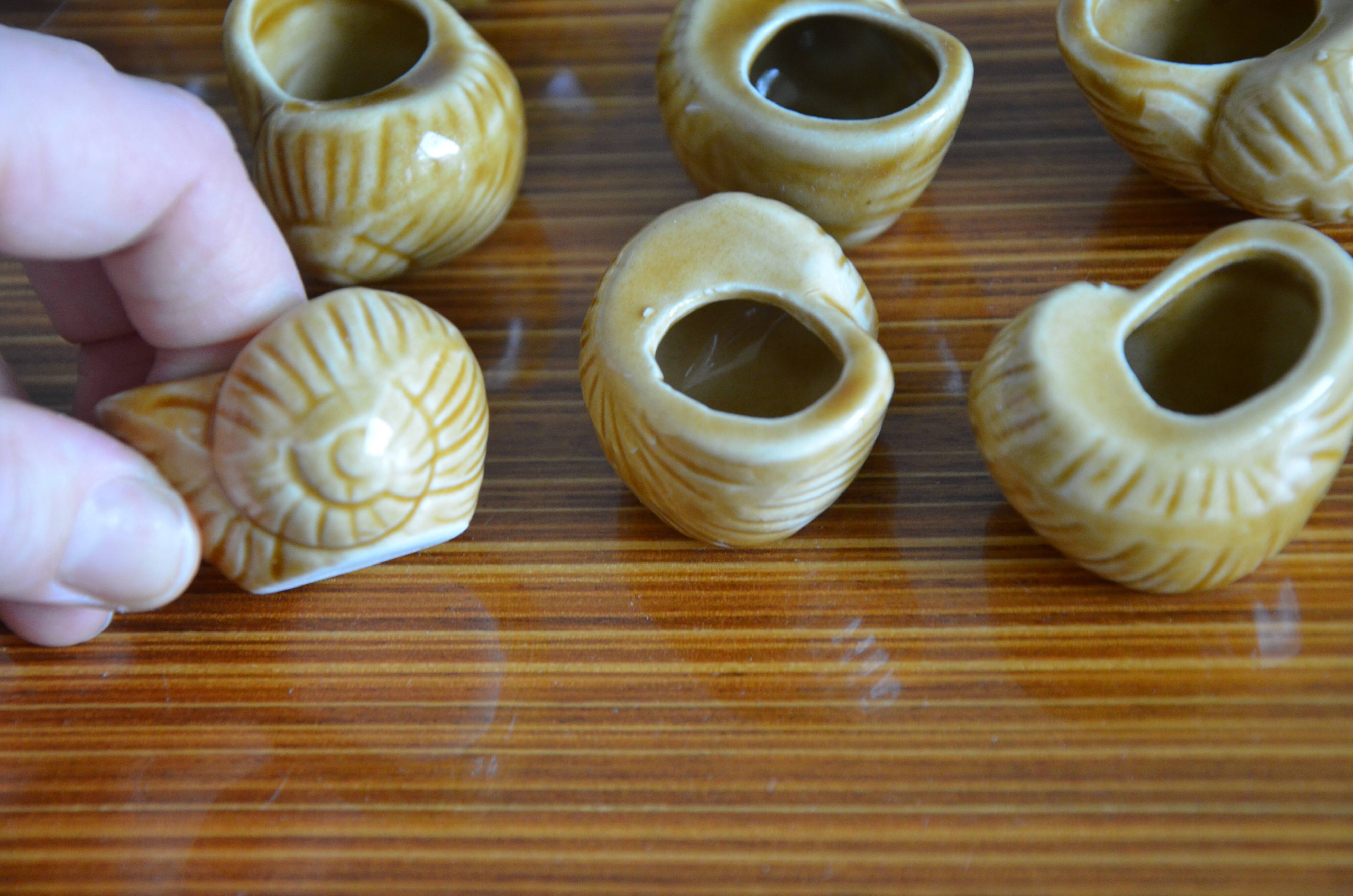 Lot of 12 enamelled sandstone snail shells