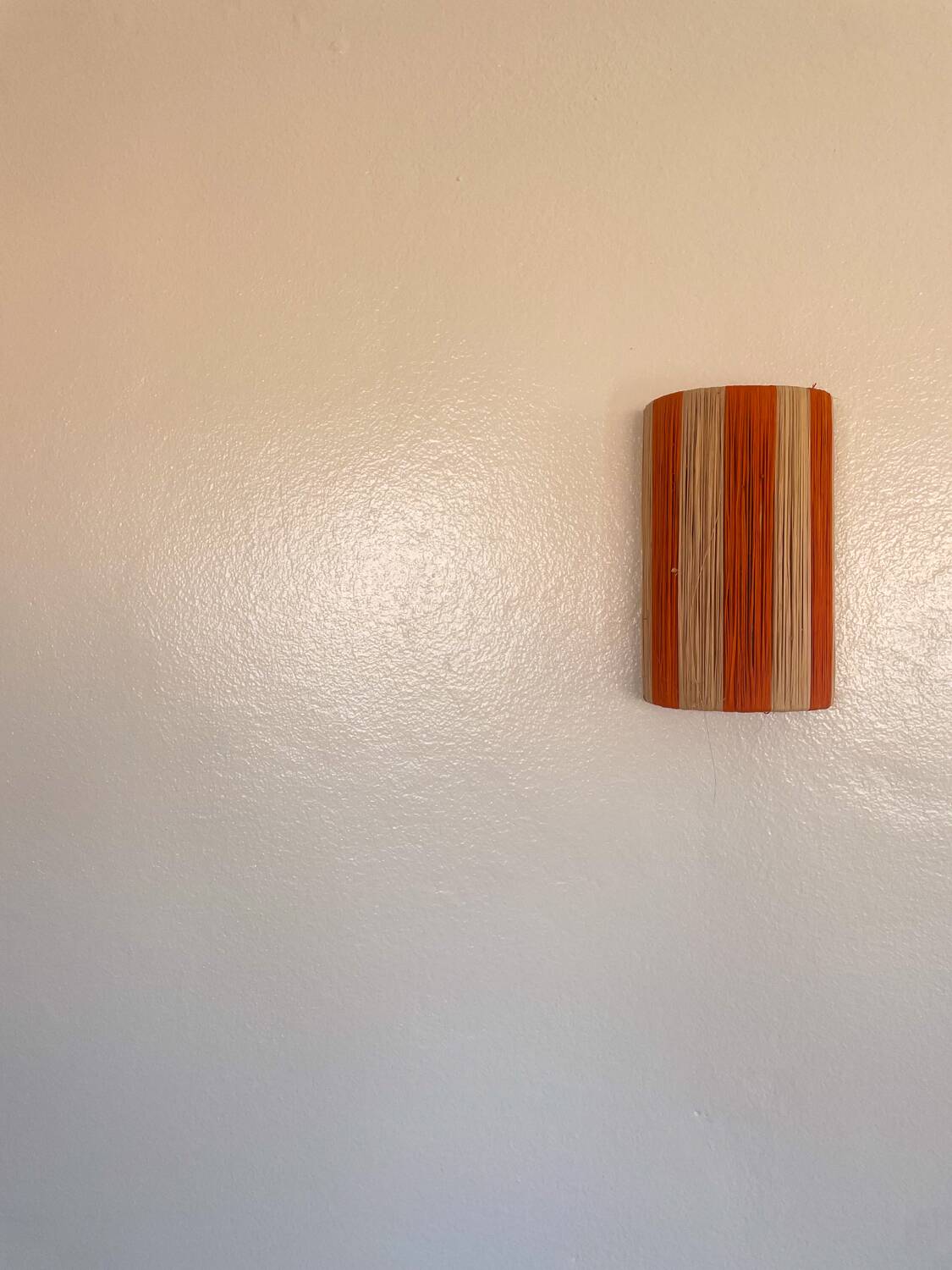 Orange and natural striped raffia wall light