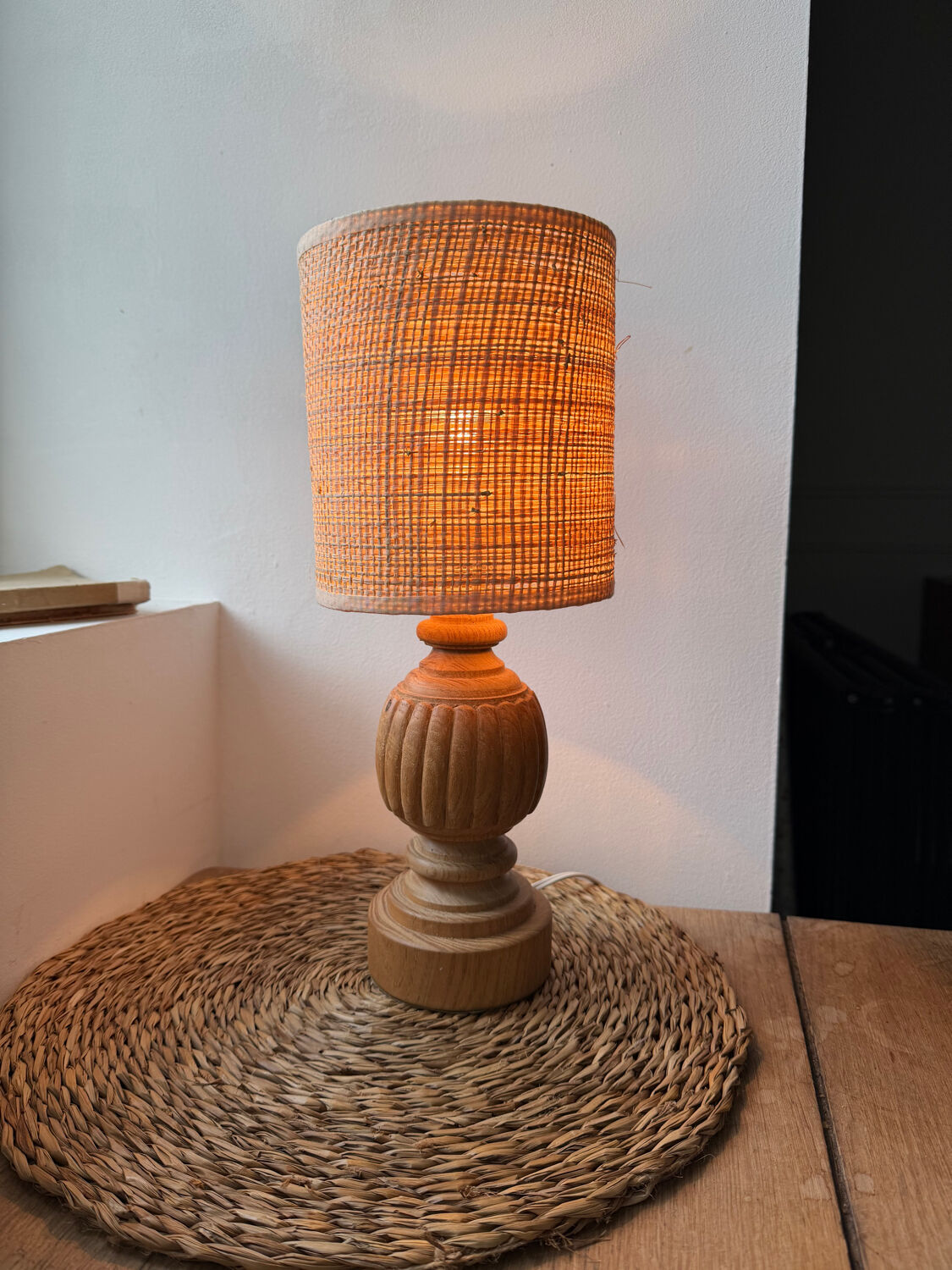 Antique table lamp with a carved wooden base.