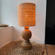 Antique table lamp with a carved wooden base.