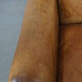 Stylish patinated vintage sheepskin armchair with a comfortable seat