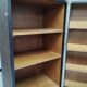 Wardrobe trunk on casters in mahogany and woven rattan.
