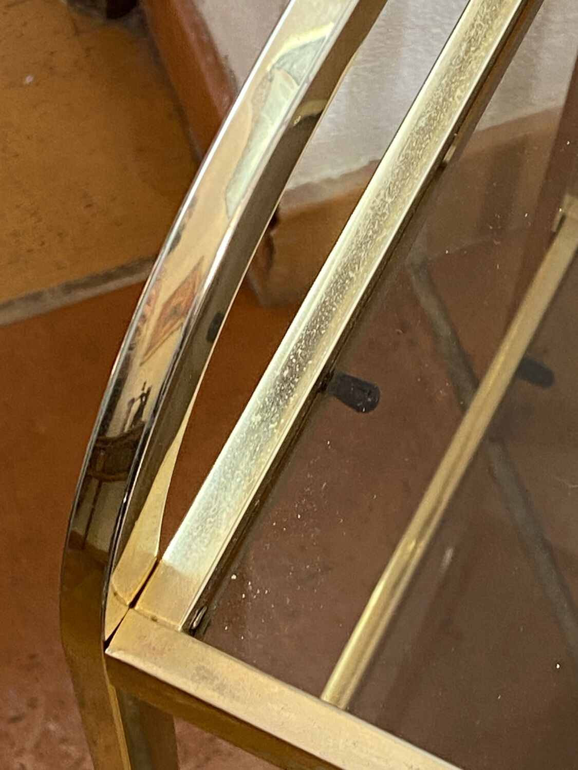 Gold metal and smoked glass console table.