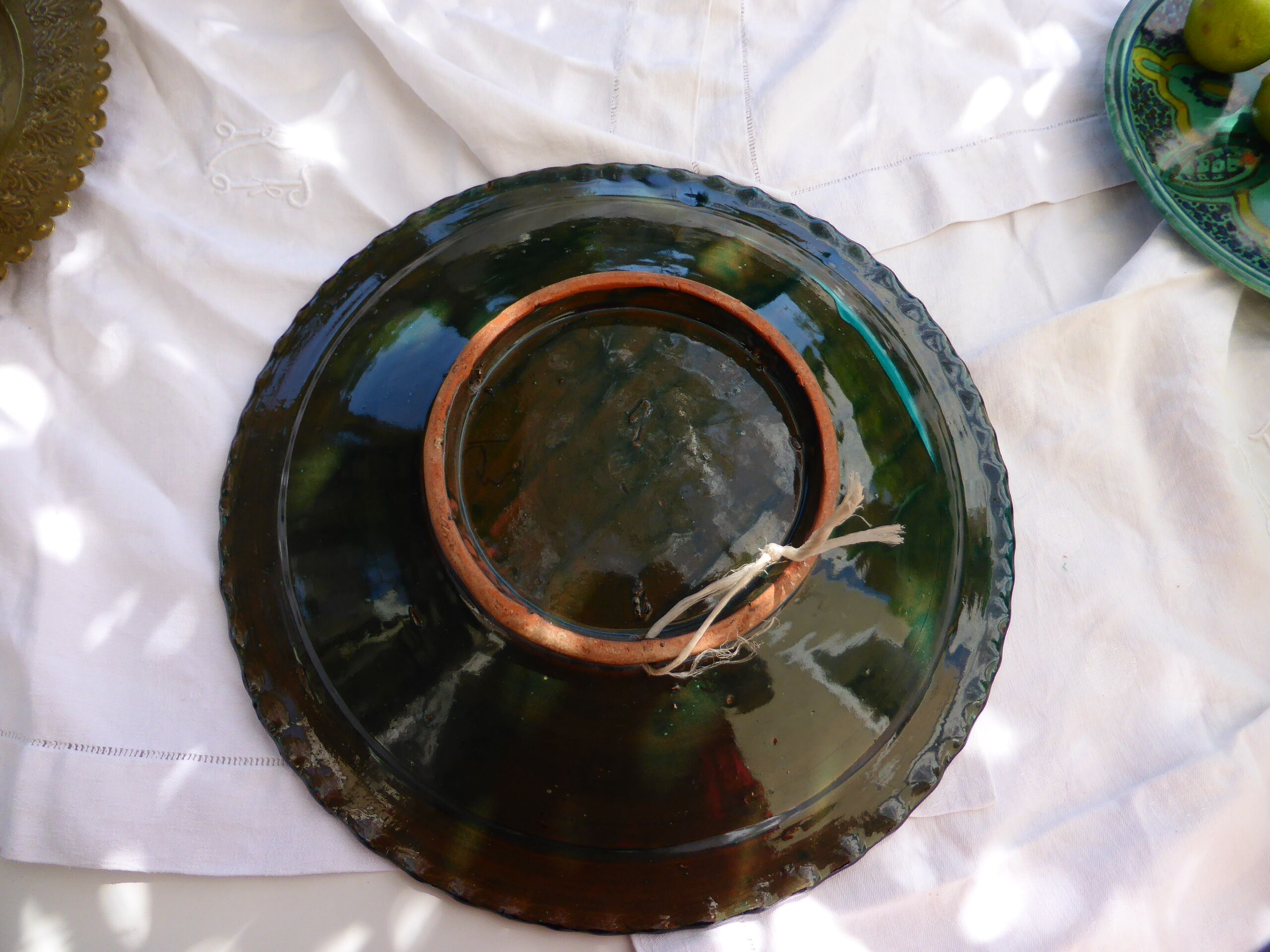 Hand-painted vintage oriental hollow dish, black patterns on a turquoise background