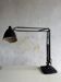 Vintage industrial articulated desk lamp in black metal with cast-iron base, adjustable arm