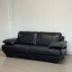 Two-seater Natuzzi sofa in navy blue leather.