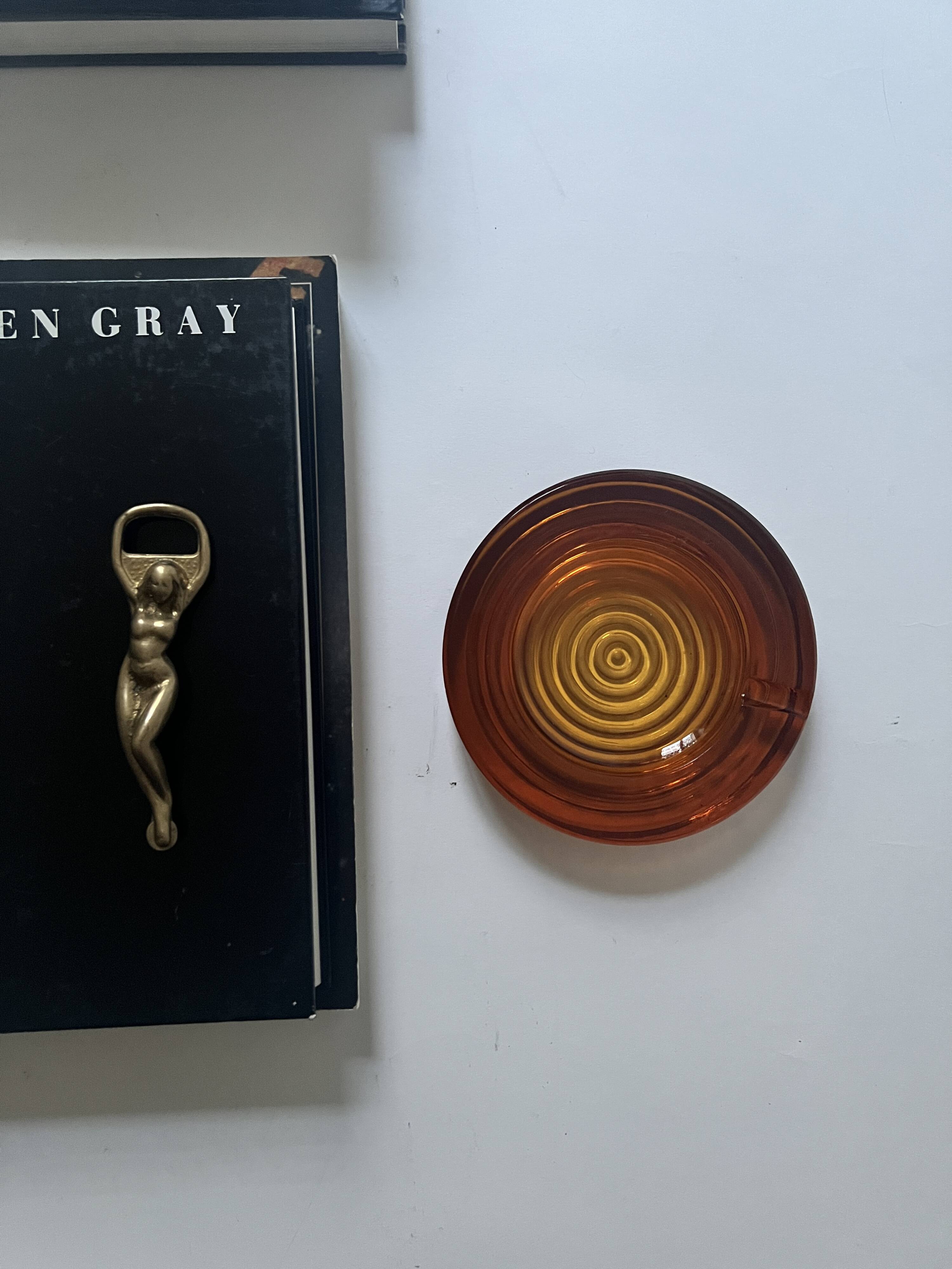 Amber pressed glass ashtray, 1970s design.