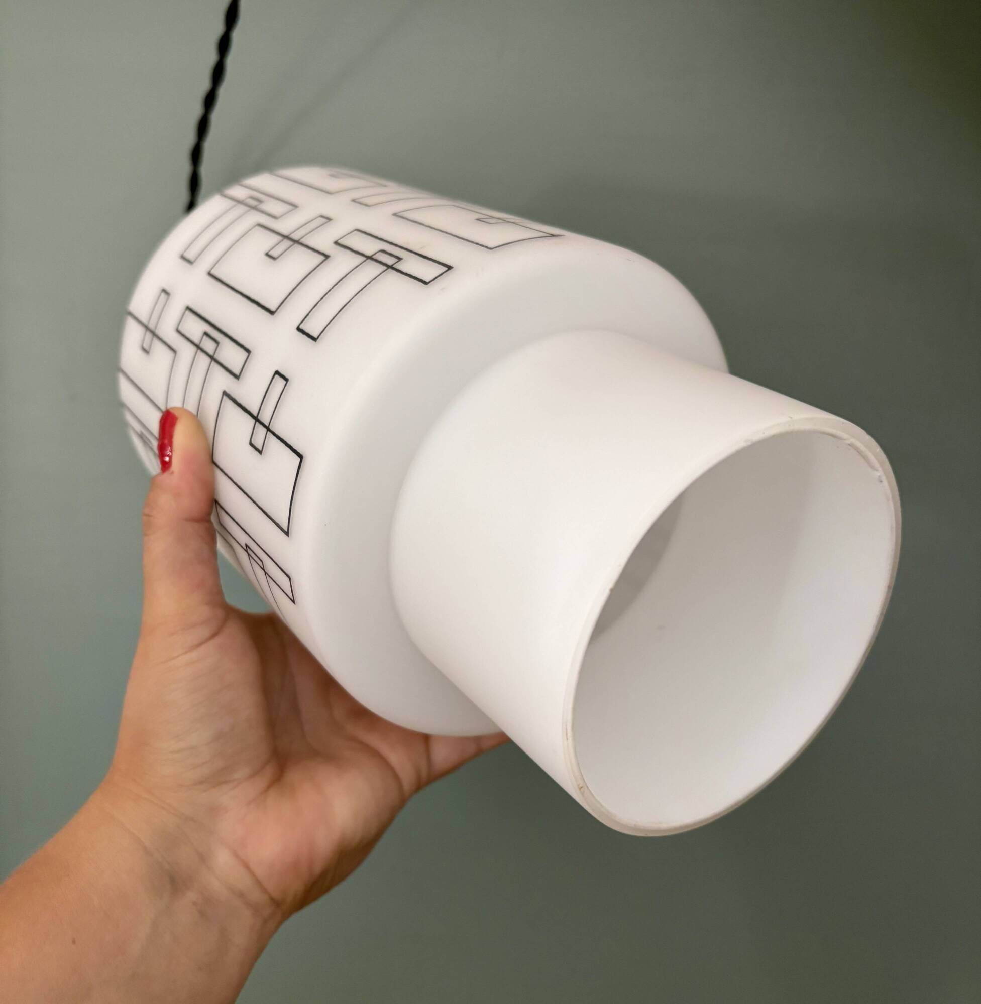 Vintage suspension globe in white opaline with black drawings.