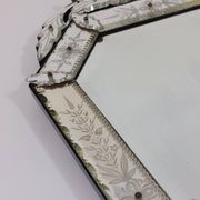 Venetian wall mirror in Murano glass with faceted floral decoration from the 1930s.