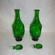 Set of 2 vintage green glass faceted carafes with stoppers.