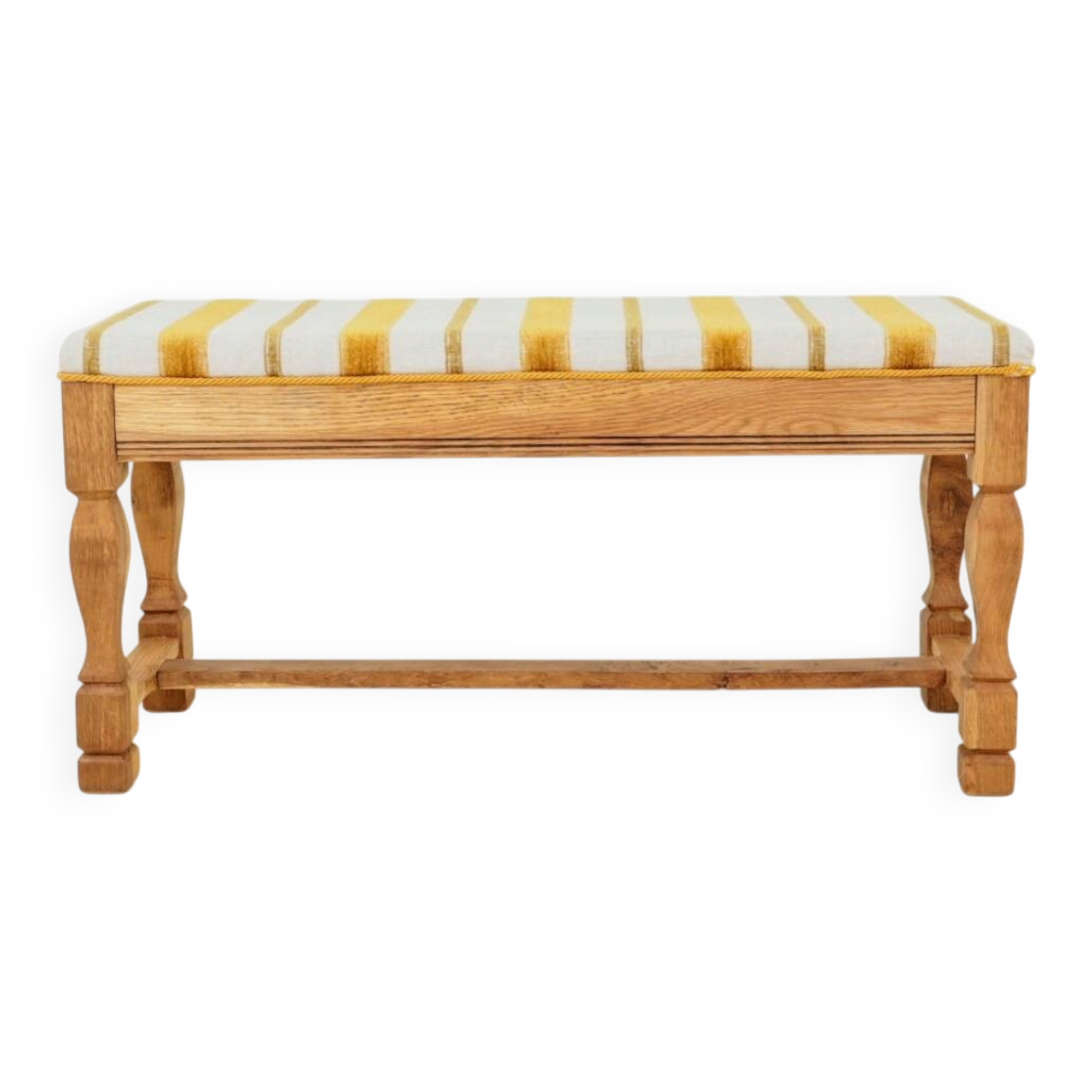 Vintage oak bench with striped linen fabric in a country style.