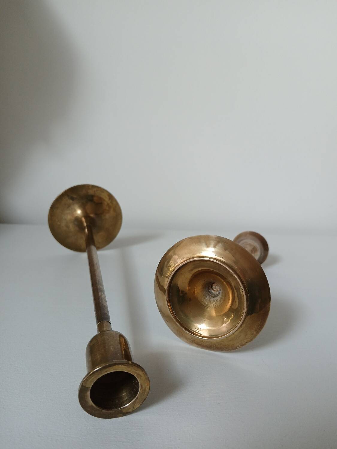 Set of two straight brass candlesticks.