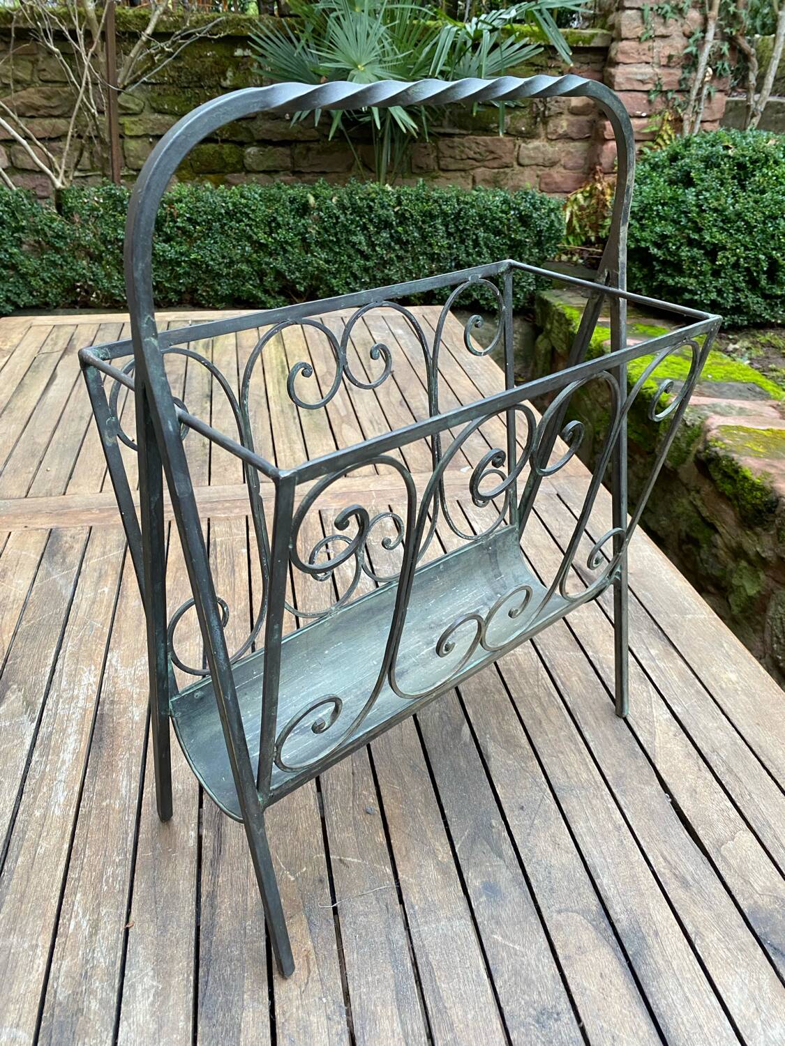 Art Deco magazine rack in wrought iron with bronze patina from around 1930-1940.