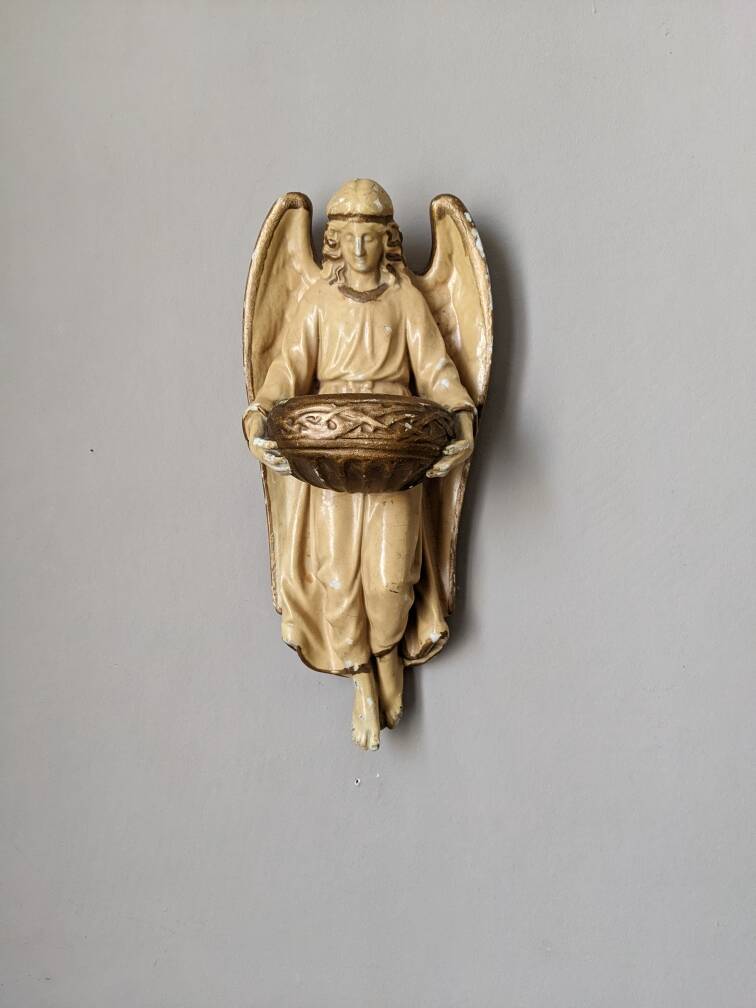 Antique ceramic holy water font with winged angel, religious object, country decoration
