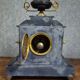 Large notary clock in black marble and gilded bronze.