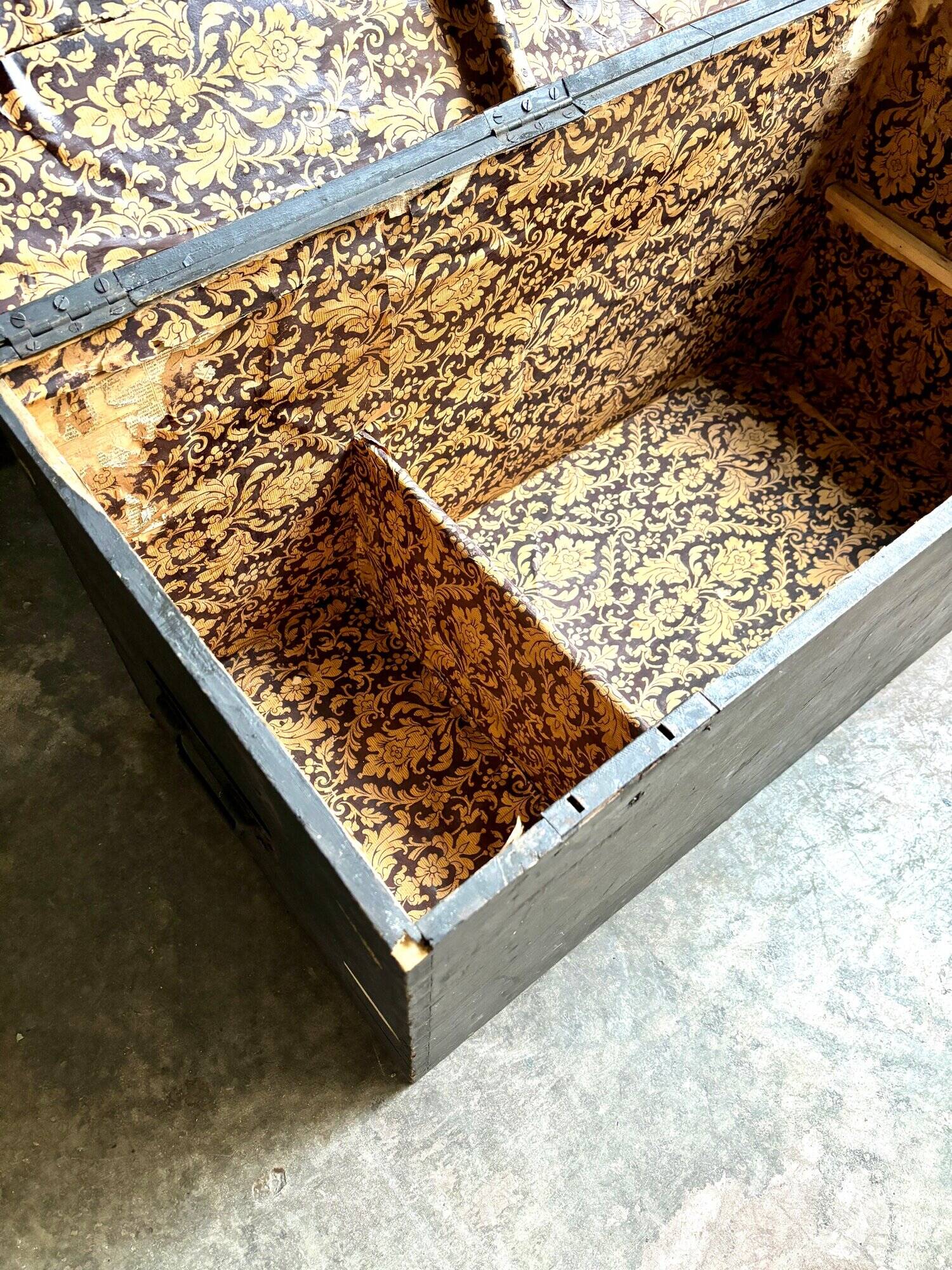 Trunk, black wooden chest and wallpaper