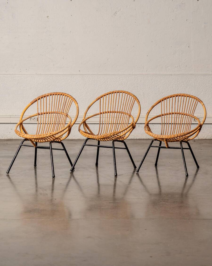 Rattan armchair with metal legs