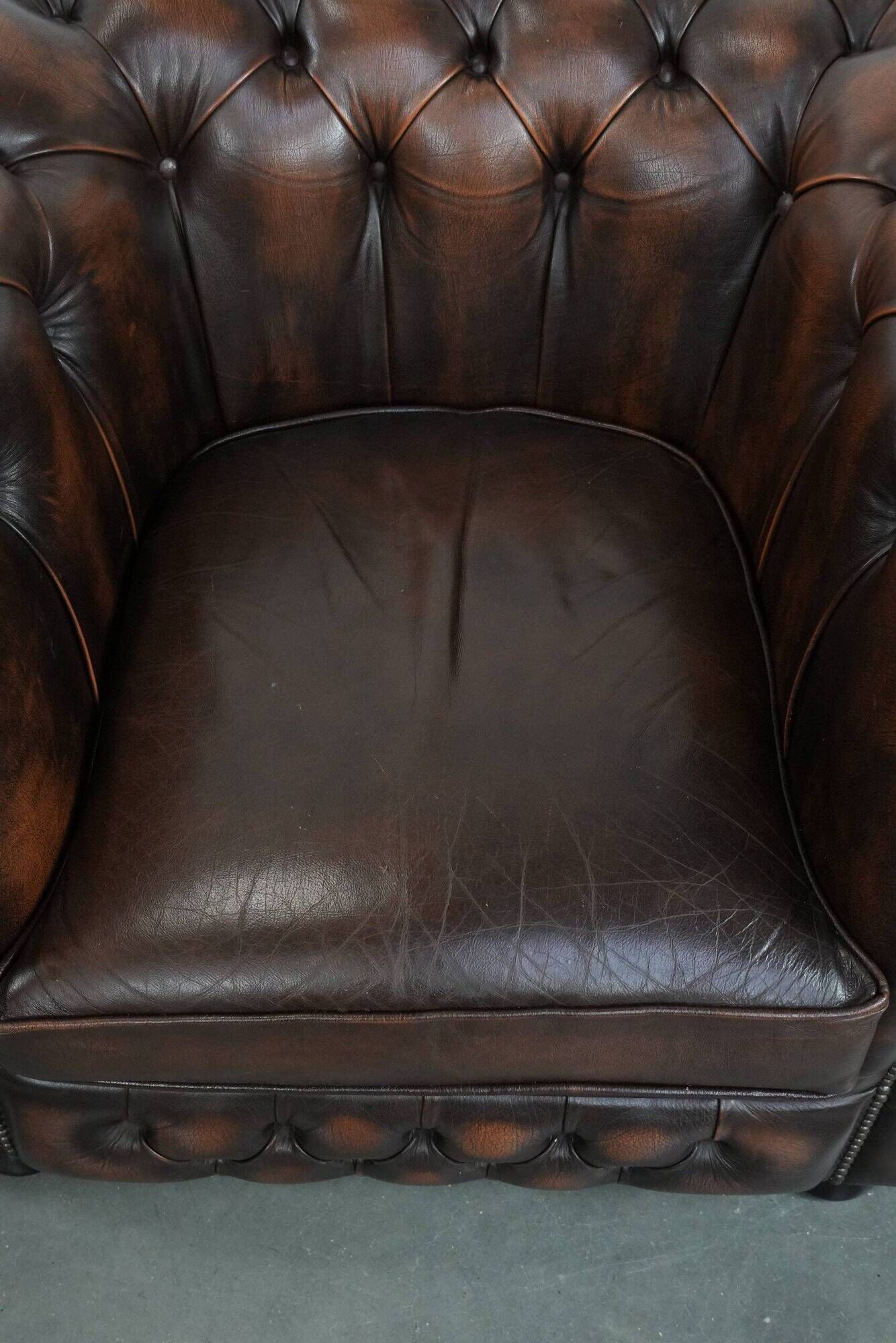 Brown Chesterfield armchair made of cowhide leather in English style