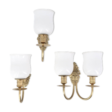 Three brass and opaque glass wall lights, 1950s.