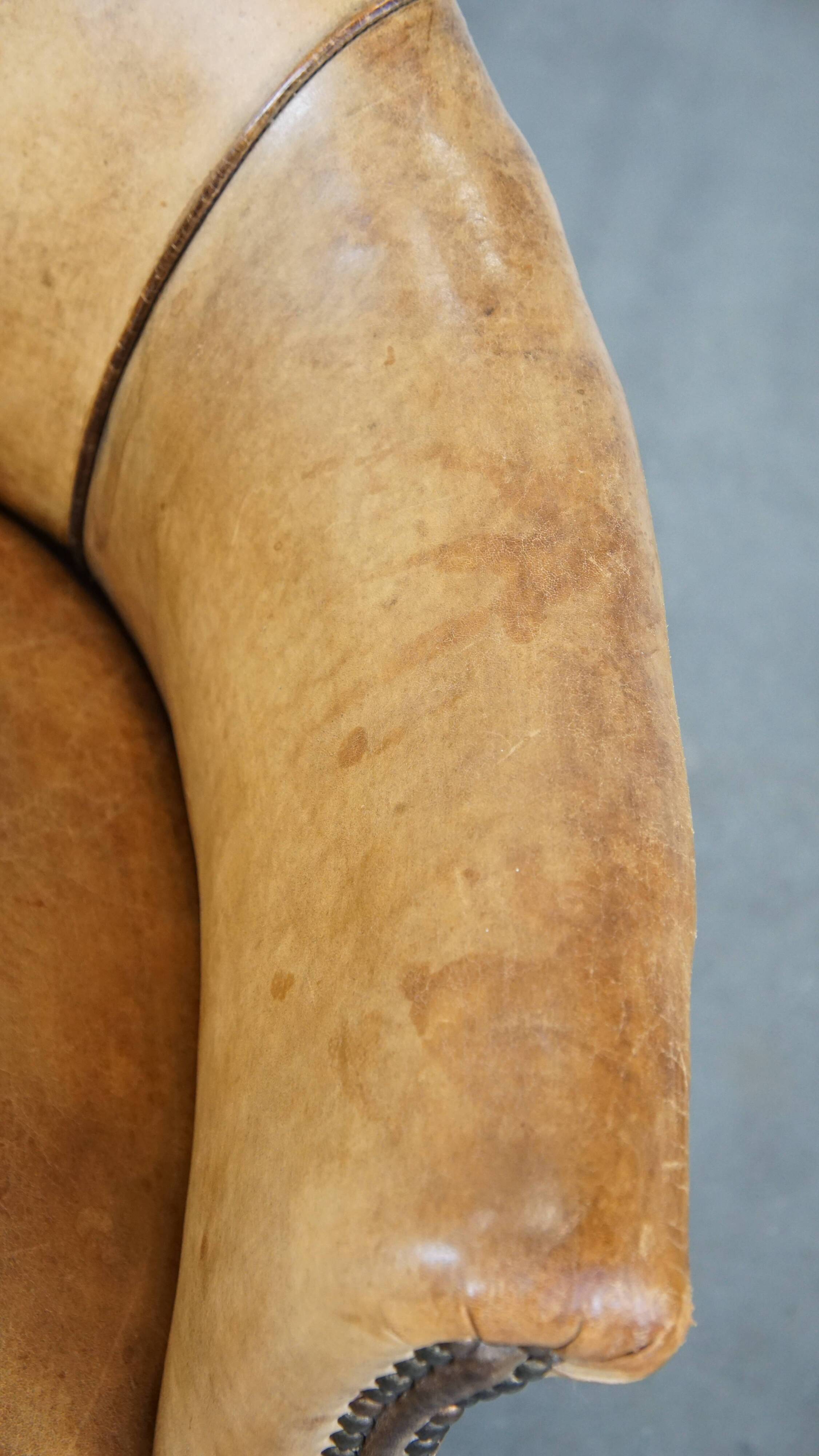 Antique sheep leather club chair/armchair on wheels