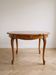 Round Louis XV dining table in solid cherry wood.