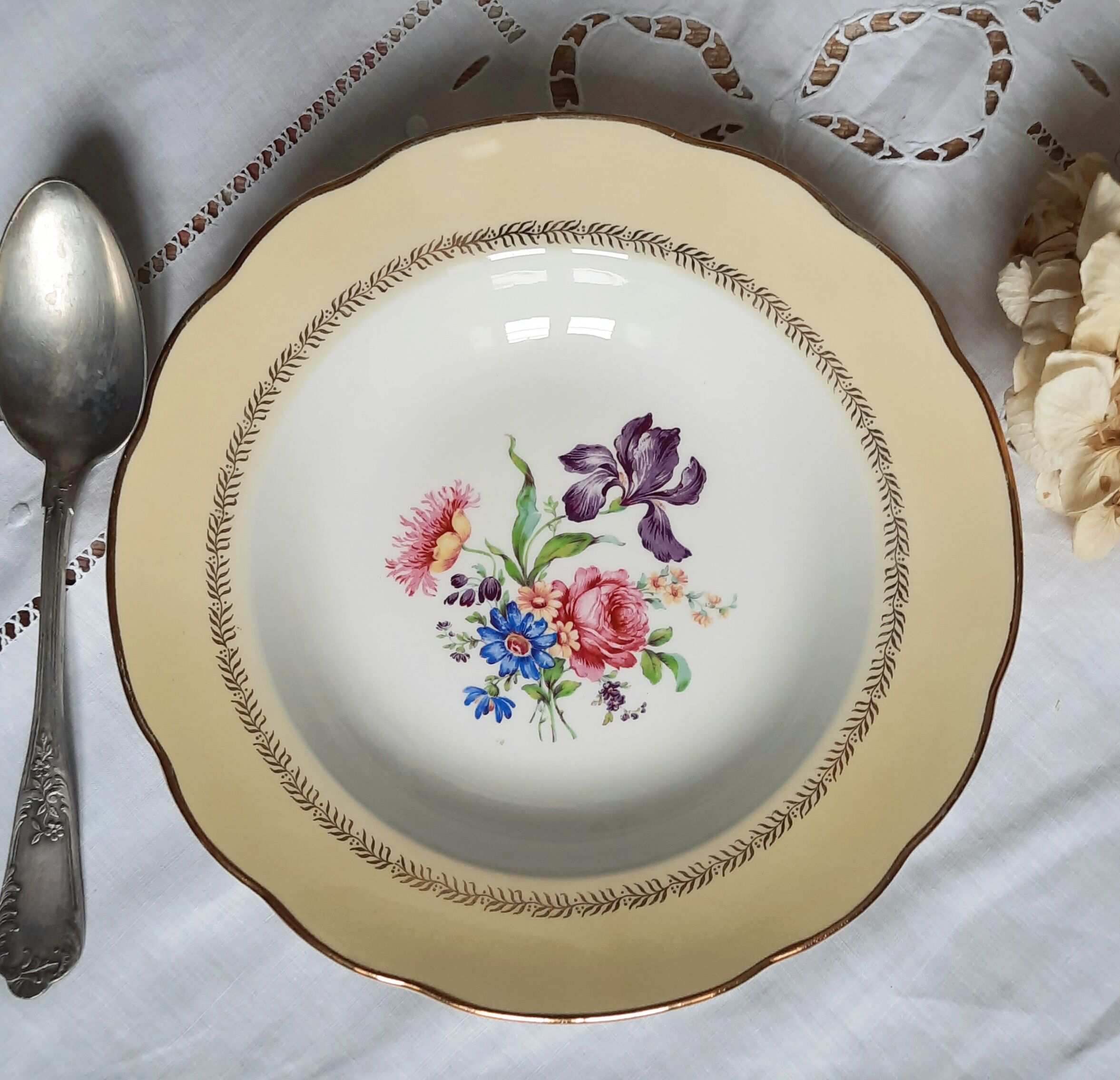 Old hollow plates mismatched in earthenware with gilded edges