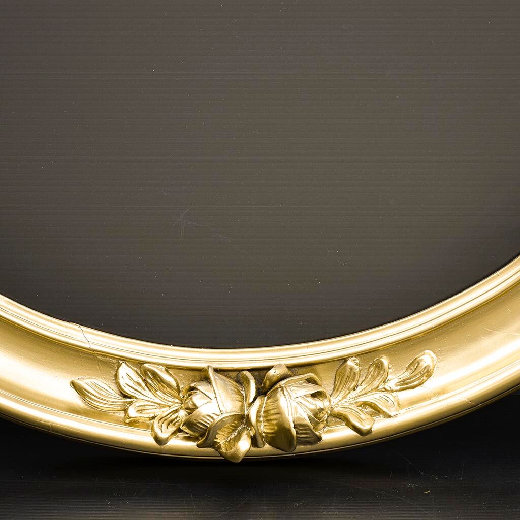 Delightful empty old gilded oval frame with carved wood and stucco flowers 63 x 53