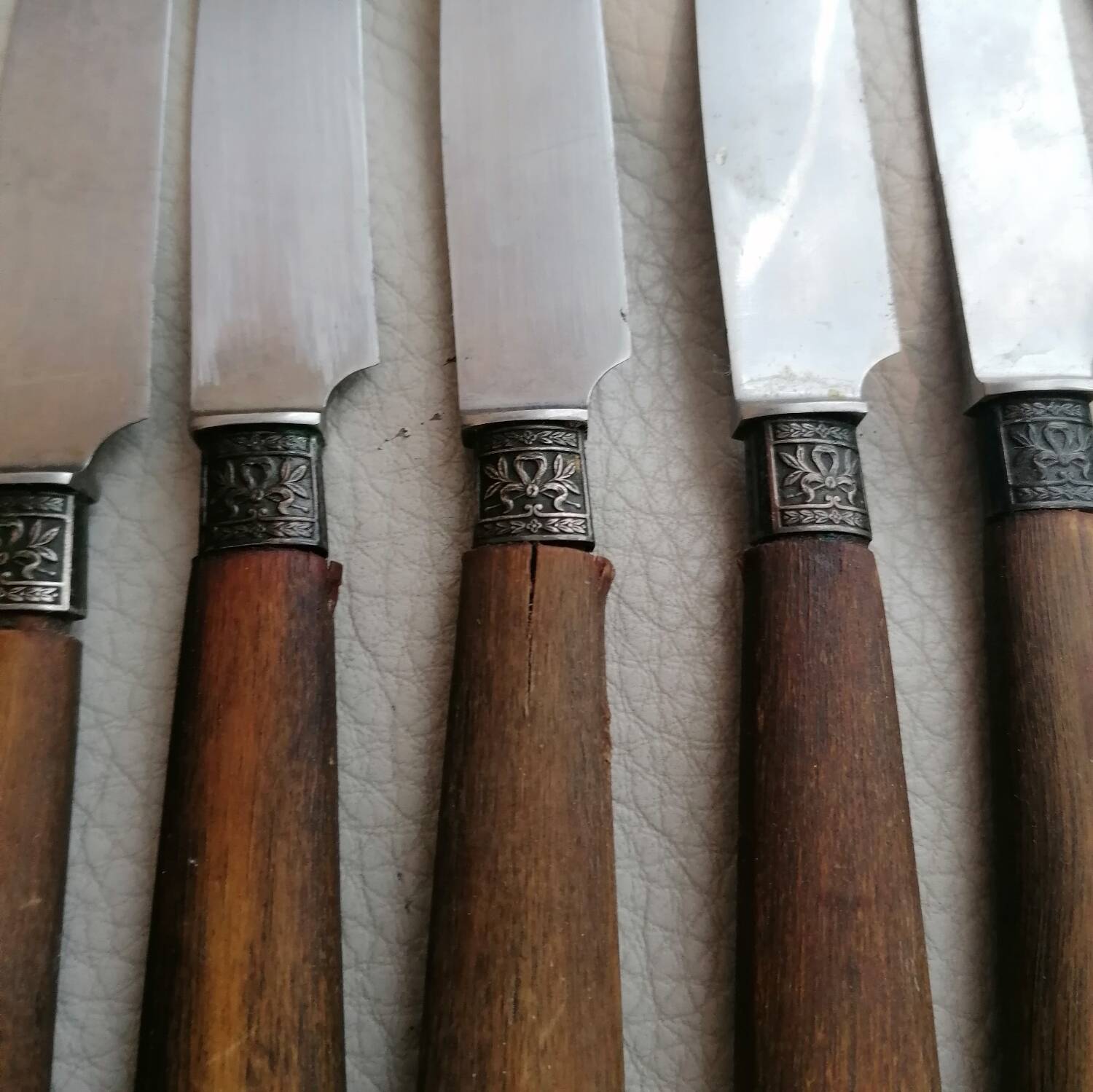 Old table knives and dessert knives, wooden handles, stainless steel blades