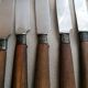 Old table knives and dessert knives, wooden handles, stainless steel blades