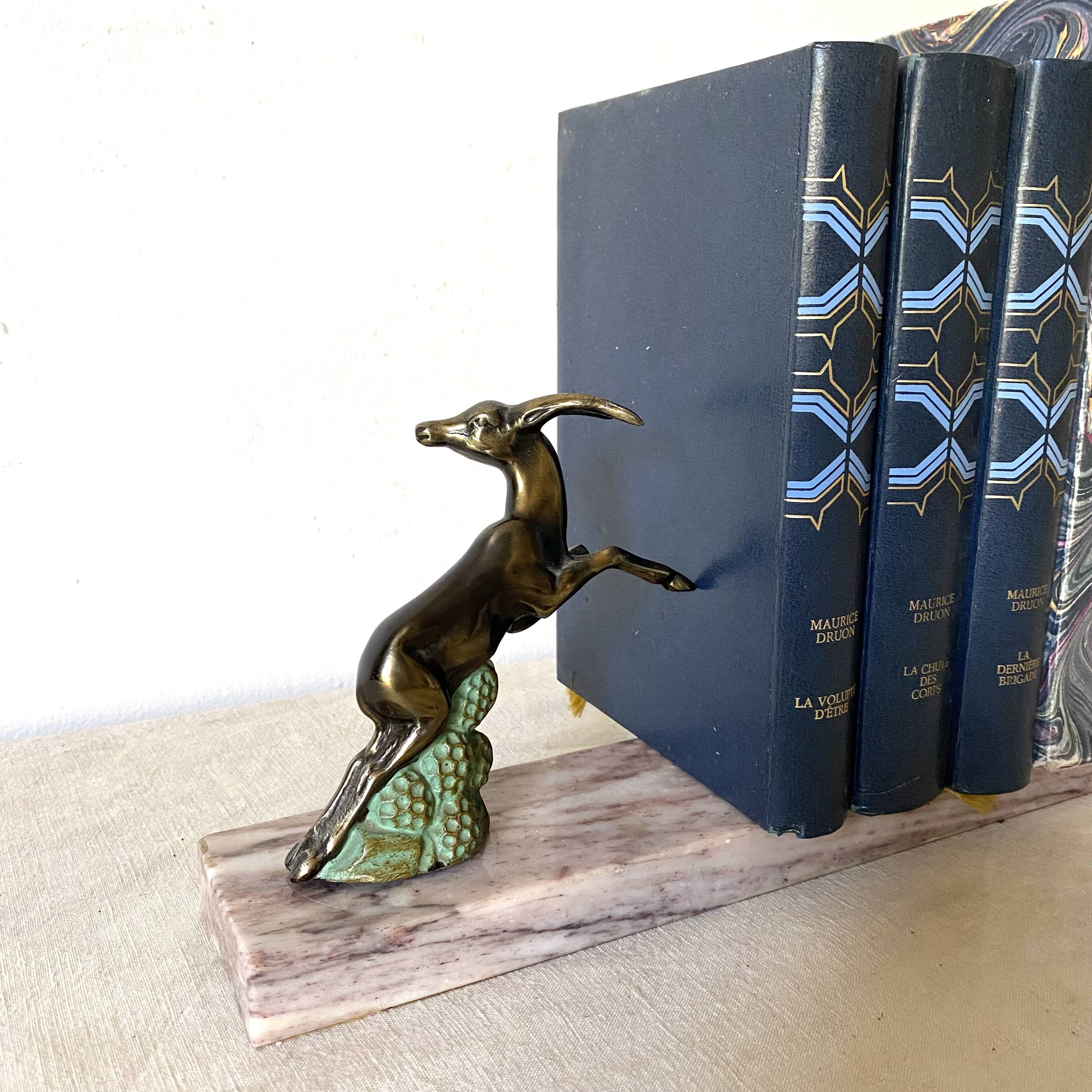 Art deco bookends in pink marble and spelters, antelopes