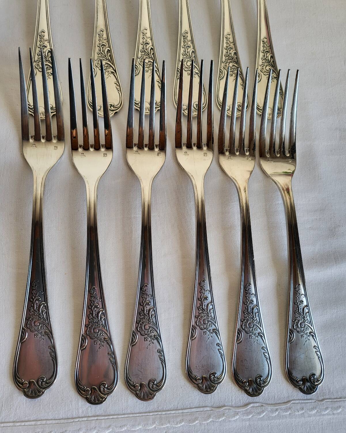 12 large silver-plated metal table forks by Guildart
