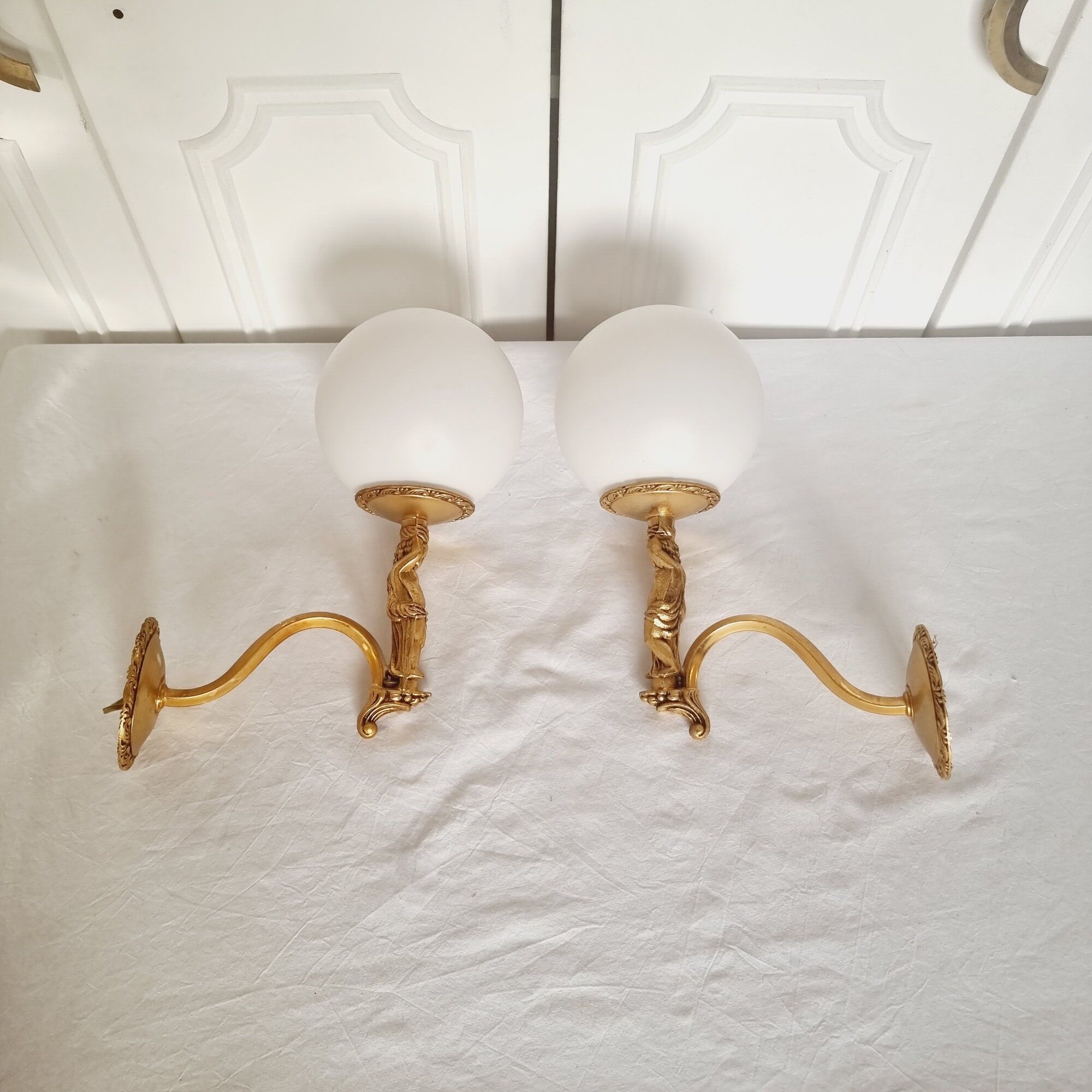 2 classic golden cherub wall lights and globe lampshades in perfect condition.