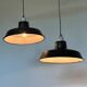 Pair of black and white industrial pendant lights with ceramic sockets