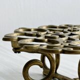 Brass trivet with openwork pattern in the shape of apples.