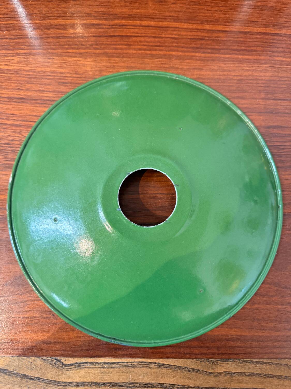 Old industrial workshop lampshade in green enamelled sheet metal.