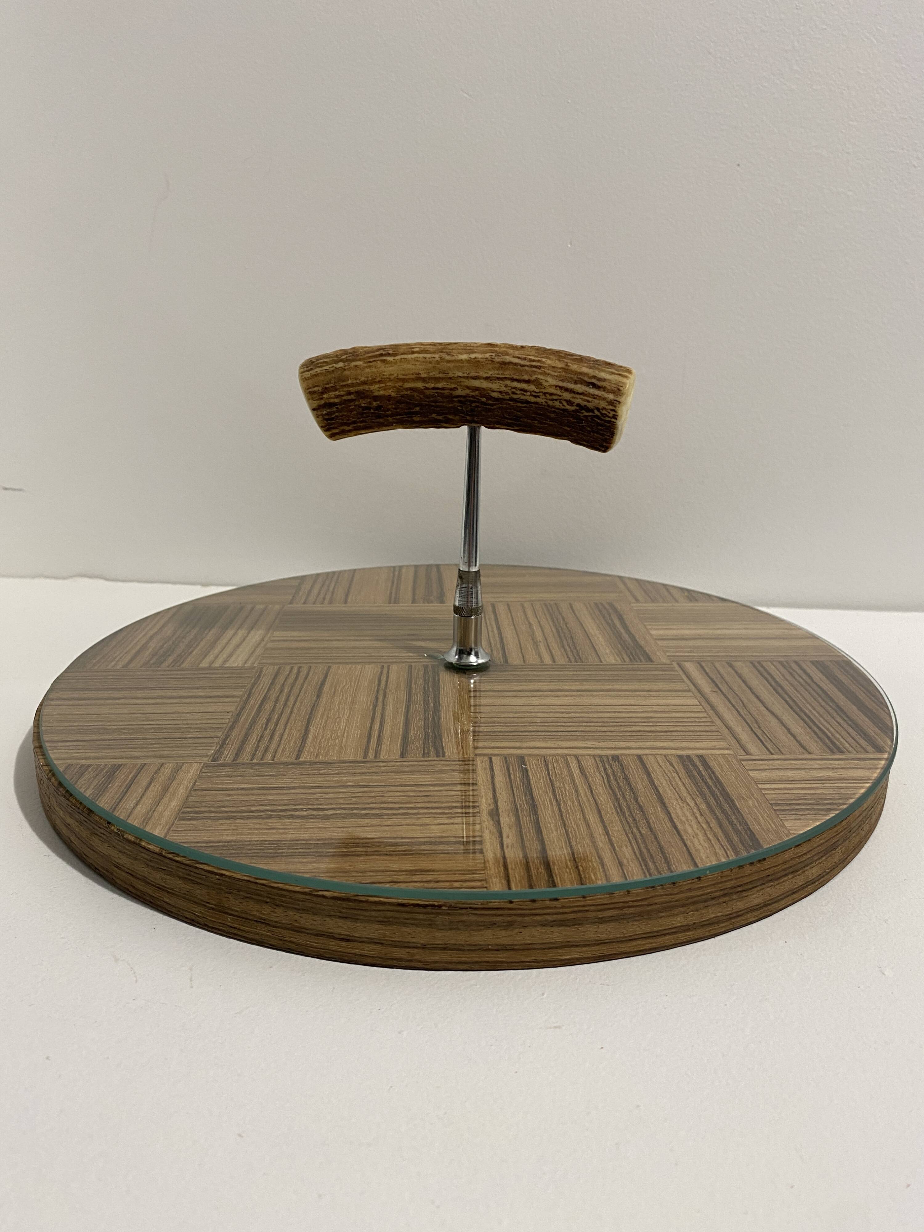 Vintage round wooden cheese board covered with glass plate with foldable handle